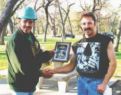[Guy LeBlanc (right), receiving First Place plaque for the 1999 International Society of Arboriculture Texas Tree Climbing Championship.]